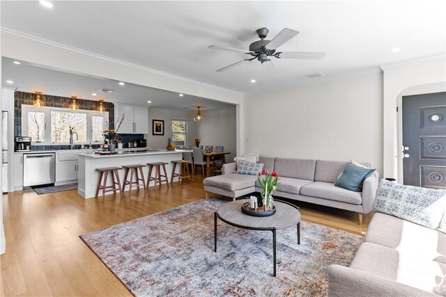 386 Stone Church Rd, Tiverton, RI 02878 - living area with ornamental molding, light wood-style floors, recessed lighting, ceiling fan, and arched walkways