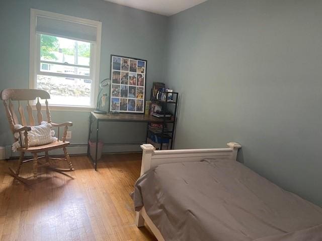386 Stone Church Rd, Tiverton, RI 02878 - bedroom with wood finished floors, baseboard heating, and baseboards