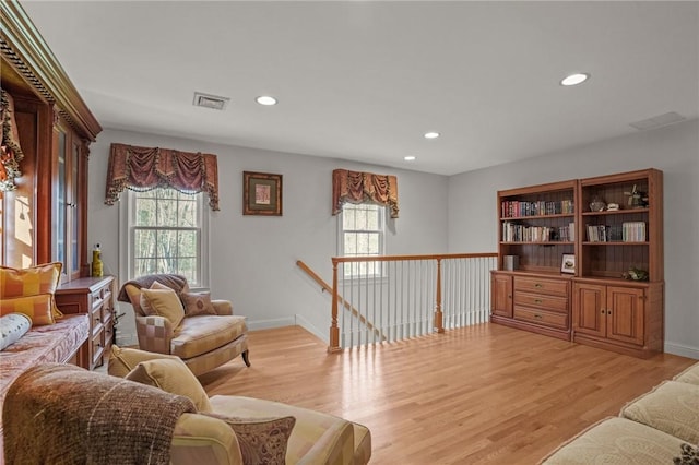 living area featuring visible vents, recessed lighting, light wood-style flooring, and a wealth of natural light