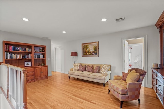 living area with recessed lighting, visible vents, and light wood-type flooring
