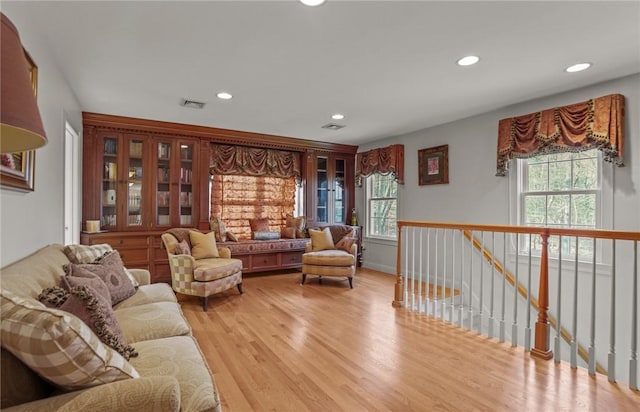 living room with visible vents, recessed lighting, and a wealth of natural light