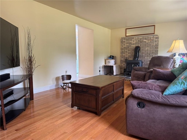 1 Gilman Rd, Hopkinton, RI 02832 - living room featuring a wood stove, light wood-style floors, and baseboards