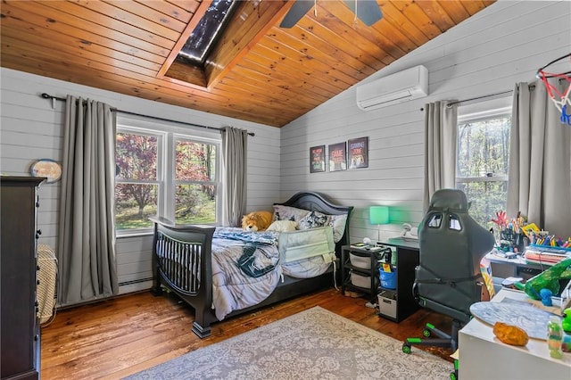 bedroom with an AC wall unit, lofted ceiling, wood-type flooring, wood walls, and a skylight