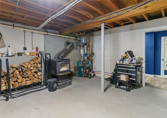 unfinished below grade area featuring a heating unit and a wood stove