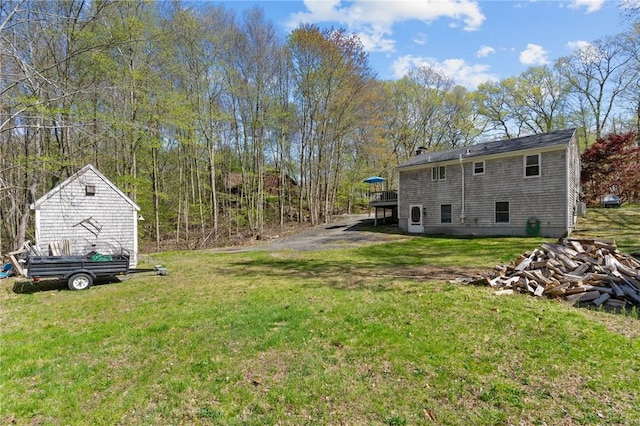 view of grassy yard featuring a wooden deck