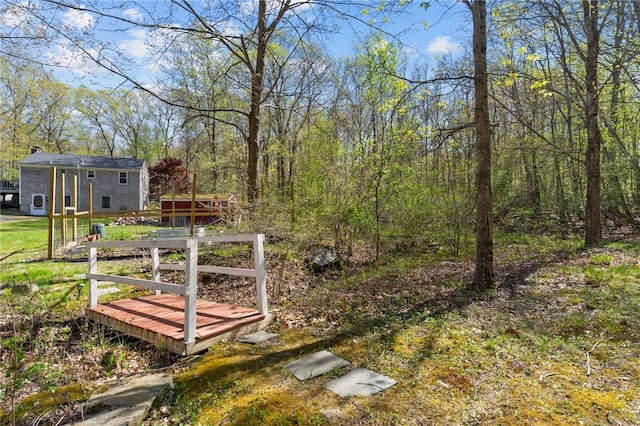 view of yard featuring an outbuilding and a forest view