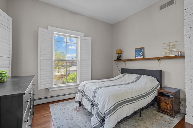 bedroom featuring a baseboard radiator and dark wood-style flooring