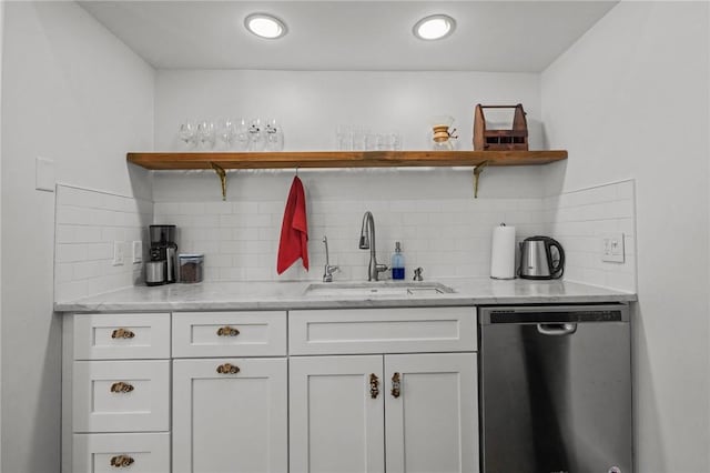 indoor bar with stainless steel dishwasher and tasteful backsplash
