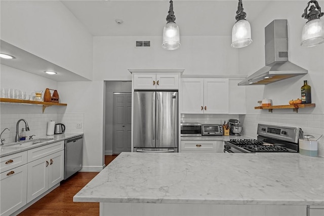 kitchen featuring stainless steel appliances, open shelves, a sink, wall chimney range hood, and tasteful backsplash