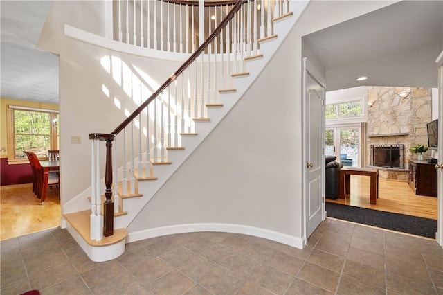 825 Woonsocket Hill Rd, North Smithfield, RI 02896 - stairs featuring baseboards, a healthy amount of sunlight, and a stone fireplace