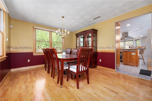 825 Woonsocket Hill Rd, North Smithfield, RI 02896 - dining room with visible vents, light wood finished floors, baseboards, and a chandelier