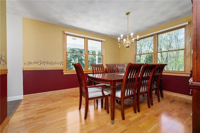 825 Woonsocket Hill Rd, North Smithfield, RI 02896 - dining space featuring baseboards, wood finished floors, and a chandelier