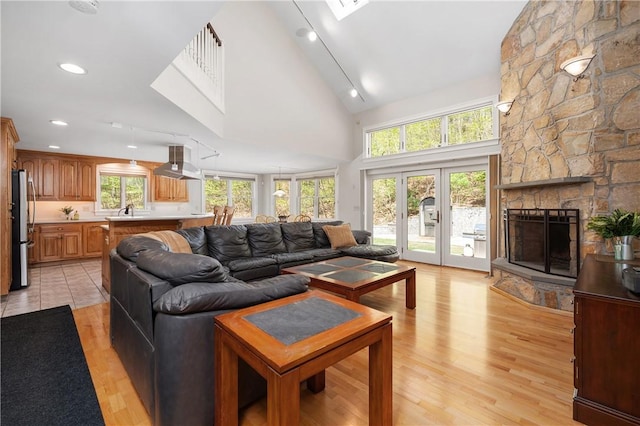 825 Woonsocket Hill Rd, North Smithfield, RI 02896 - living room with high vaulted ceiling, a wealth of natural light, and light wood-style floors