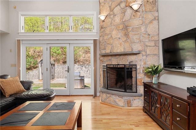 825 Woonsocket Hill Rd, North Smithfield, RI 02896 - living area featuring french doors, wood finished floors, and a stone fireplace