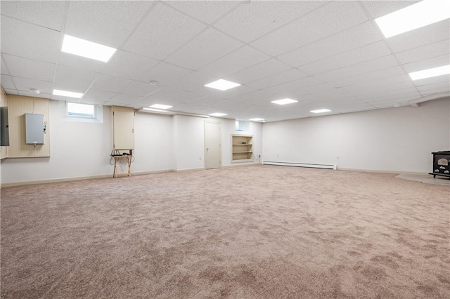 825 Woonsocket Hill Rd, North Smithfield, RI 02896 - basement with a wood stove, carpet, a drop ceiling, and baseboard heating
