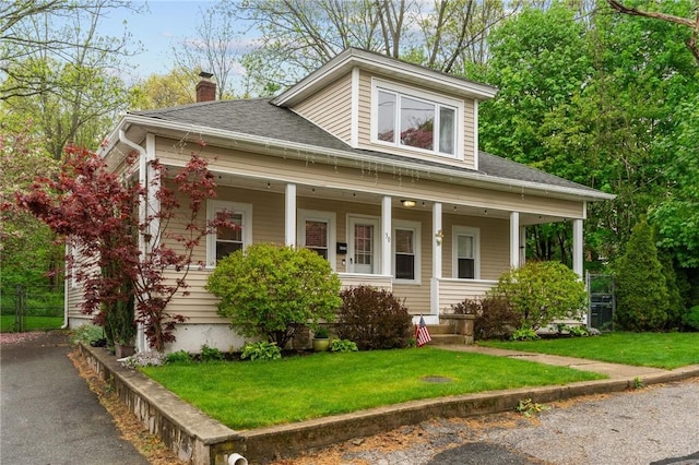 30 Hebert St, Coventry, RI 02816 - bungalow-style house with a porch, roof with shingles, a chimney, and a front yard