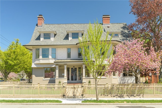 349 Wayland Ave, Providence, RI 02906 - view of front of home with a porch, a chimney, a fenced front yard, and a gate