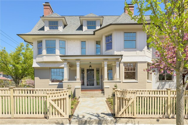 349 Wayland Ave, Providence, RI 02906 - victorian home featuring a gate, covered porch, a chimney, and a fenced front yard