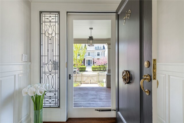 349 Wayland Ave, Providence, RI 02906 - doorway to outside featuring a decorative wall, a wainscoted wall, and crown molding