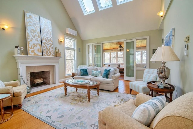 27 Tom Harvey Rd, Westerly, RI 02891 - living room featuring high vaulted ceiling, a skylight, wood finished floors, a fireplace, and baseboards