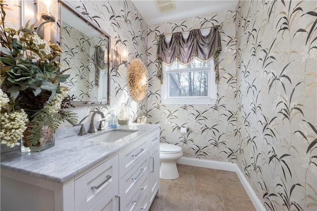 27 Tom Harvey Rd, Westerly, RI 02891 - bathroom with wallpapered walls, baseboards, toilet, vanity, and tile patterned floors