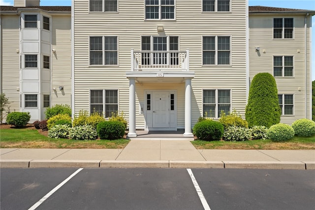 view of exterior entry featuring uncovered parking