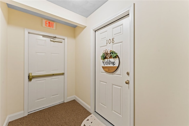 entryway featuring baseboards and carpet flooring