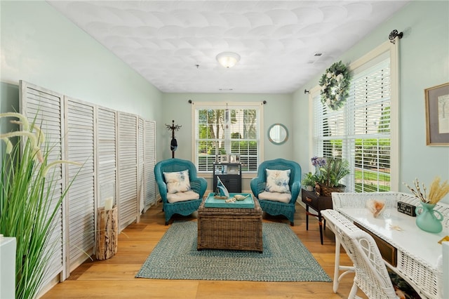 sitting room with visible vents and light wood finished floors