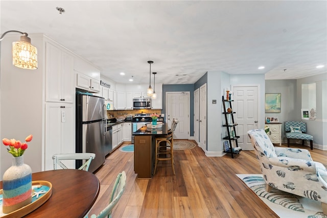 interior space featuring baseboards, light wood-type flooring, and recessed lighting