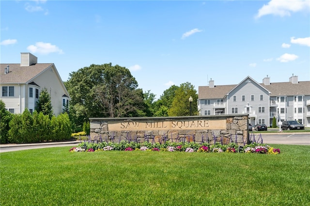 community sign featuring a lawn