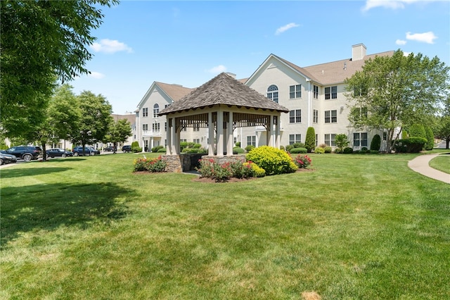 view of community featuring a lawn and a gazebo