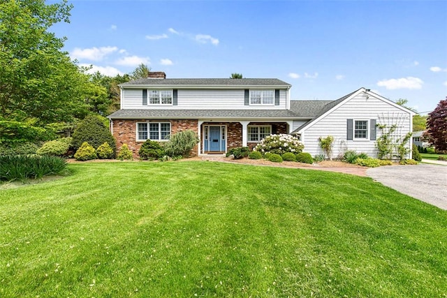 28 Potter Hill Rd, Westerly, RI 02891 - traditional-style home with a front lawn, a chimney, and brick siding