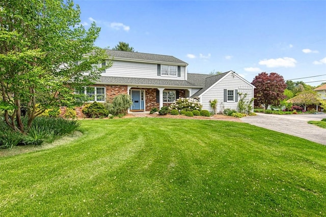 28 Potter Hill Rd, Westerly, RI 02891 - traditional home featuring a front yard and brick siding