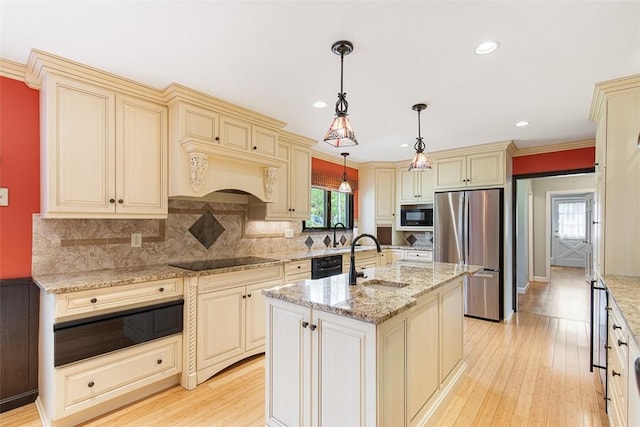 28 Potter Hill Rd, Westerly, RI 02891 - kitchen with cream cabinetry, black appliances, a sink, light wood finished floors, and healthy amount of natural light