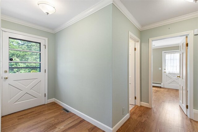 28 Potter Hill Rd, Westerly, RI 02891 - doorway to outside with a baseboard heating unit, light wood-style flooring, ornamental molding, and baseboards