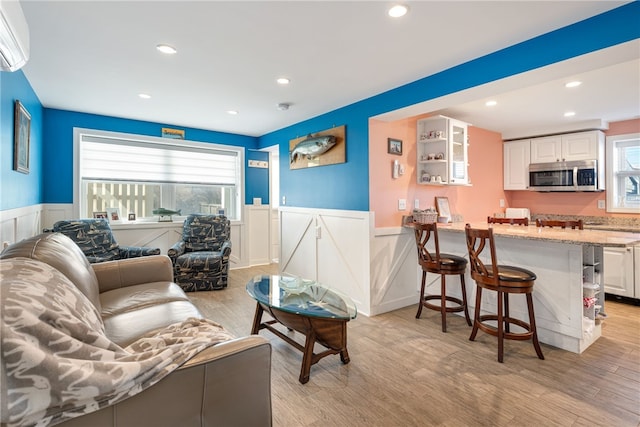 6 Macalder St, Narragansett, RI 02882 - living area featuring a decorative wall, an AC wall unit, recessed lighting, and a wainscoted wall