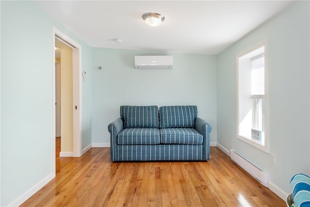 6 Macalder St, Narragansett, RI 02882 - sitting room featuring baseboards, a baseboard heating unit, a wall mounted AC, and light wood-style floors