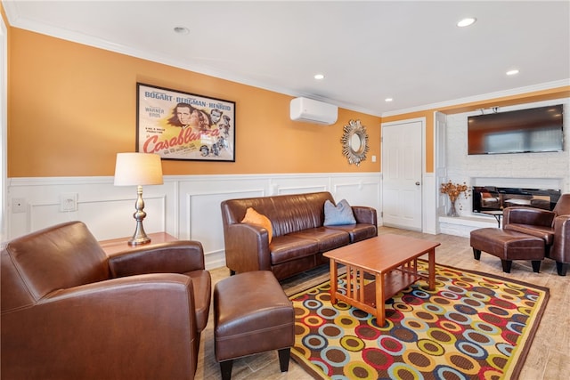 living room featuring crown molding, wainscoting, a fireplace, a wall mounted air conditioner, and wood finished floors