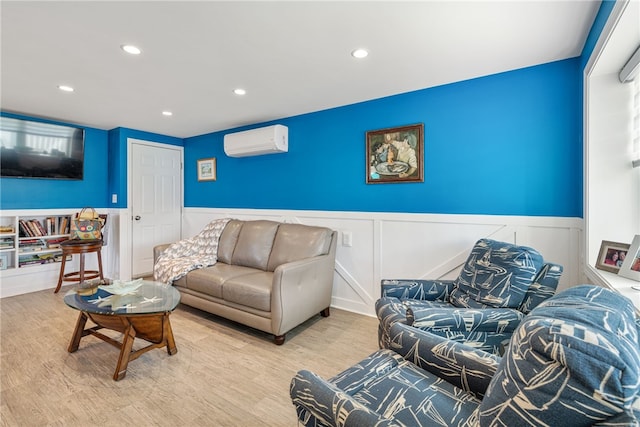 living area featuring wood finished floors, recessed lighting, a wainscoted wall, and a wall mounted air conditioner
