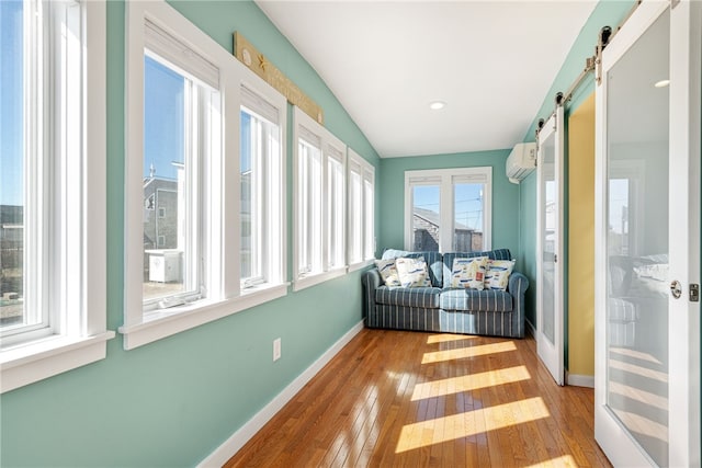 sunroom / solarium with an AC wall unit and a barn door