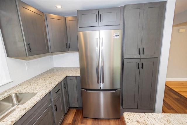 2 King St, Johnston, RI 02919 - kitchen featuring freestanding refrigerator, wood finished floors, light stone countertops, tasteful backsplash, and recessed lighting