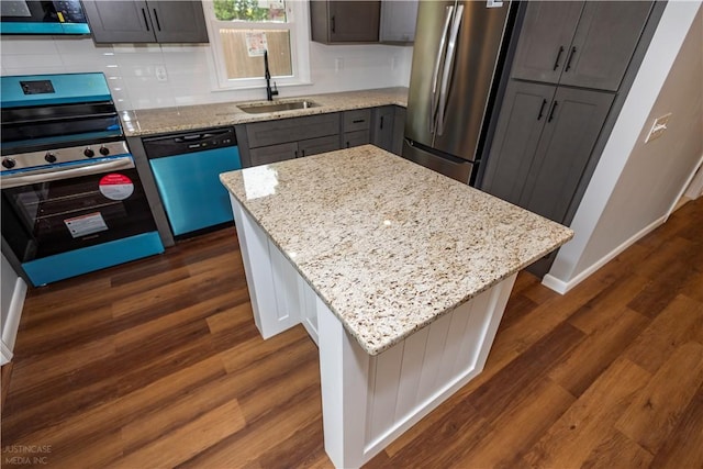 2 King St, Johnston, RI 02919 - kitchen with light stone countertops, a sink, decorative backsplash, dark wood-type flooring, and stainless steel appliances