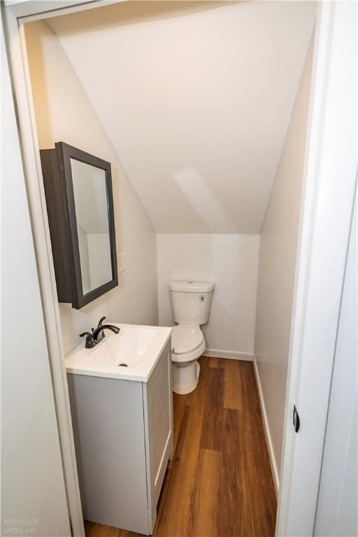 2 King St, Johnston, RI 02919 - bathroom featuring lofted ceiling, toilet, wood finished floors, vanity, and baseboards