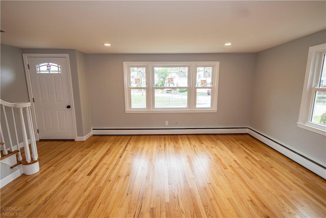 2 King St, Johnston, RI 02919 - foyer featuring a wealth of natural light, light wood-style flooring, and a baseboard heating unit