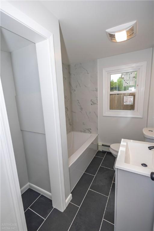 2 King St, Johnston, RI 02919 - full bath with vanity, toilet, baseboard heating, and tile patterned flooring