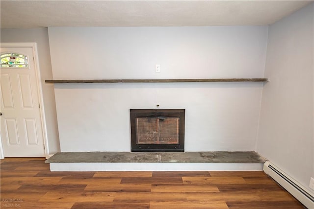 2 King St, Johnston, RI 02919 - details with a baseboard heating unit, a glass covered fireplace, and wood finished floors