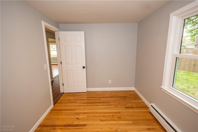 2 King St, Johnston, RI 02919 - unfurnished room featuring a baseboard heating unit, baseboards, and light wood-type flooring