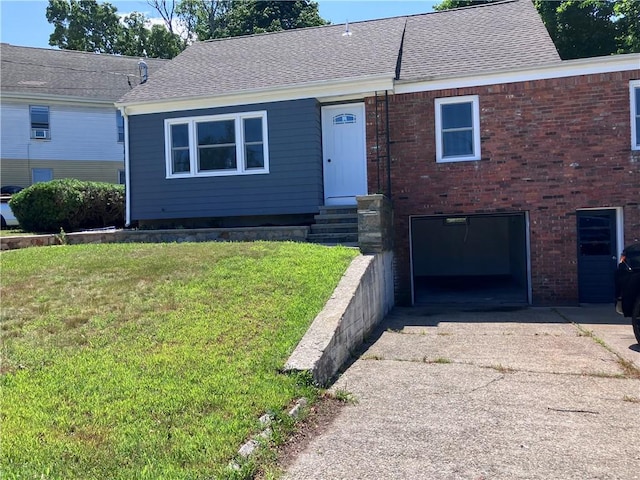 2 King St, Johnston, RI 02919 - view of front of house featuring driveway, a front lawn, an attached garage, a shingled roof, and brick siding