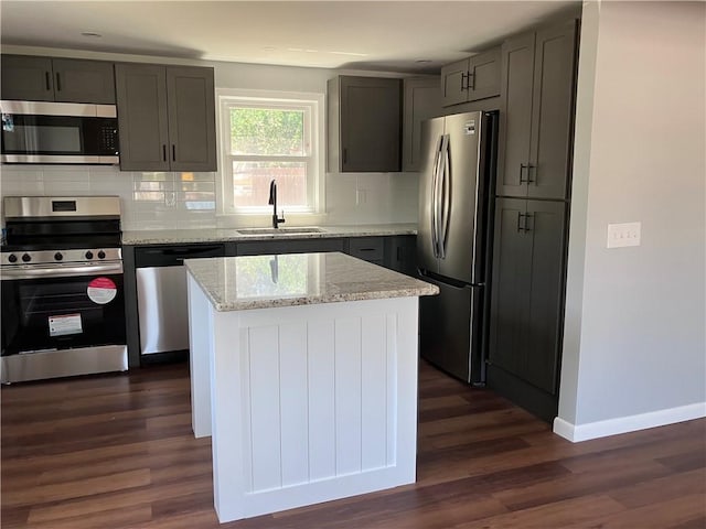 2 King St, Johnston, RI 02919 - kitchen with stainless steel appliances, dark wood-type flooring, tasteful backsplash, light stone counters, and gray cabinets