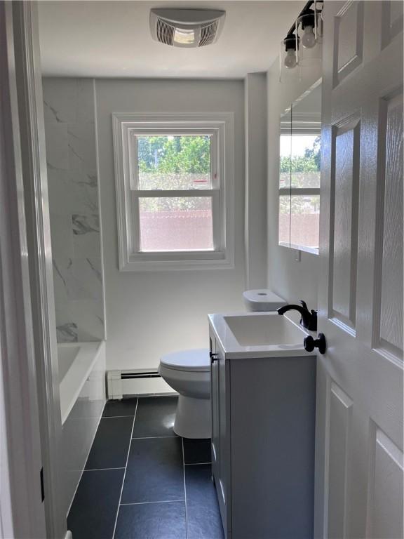 2 King St, Johnston, RI 02919 - bathroom featuring a baseboard radiator, vanity, tile patterned flooring, and tub / shower combination